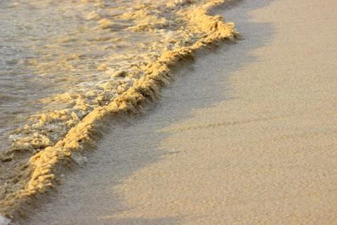 Sandy swirl of the surf Stock Photos