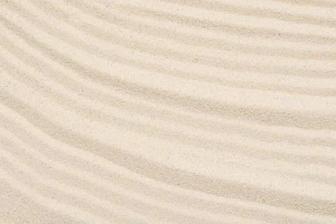 Sandy texture, abstract lines on the top of soft sand, top view, layout Stock Photos