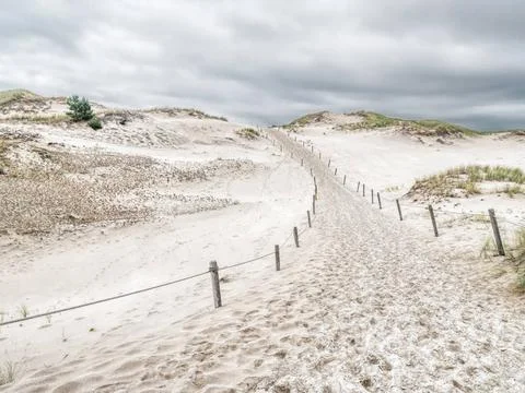 Sandy trail withing the moving dune Wydma Czolpinska in the the Slowinski ... Stock Photos