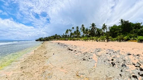 Sandy tropical beach with rocky shore and palm trees. Siargao, Philippines. Stock Footage 337447059