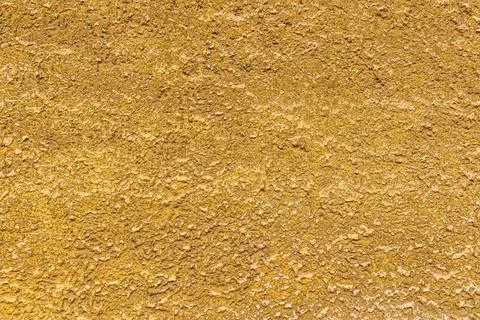 Sandy yellow, bumpy surface, plaster with abrasions Stock Photos