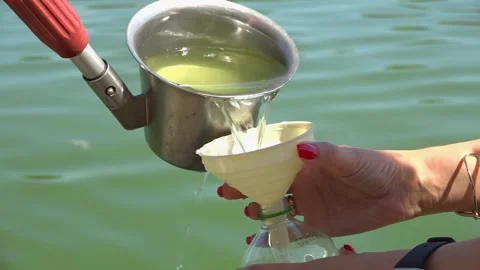 Sanitary service officer testing river water quality during hot summer heatwave. Stock Footage 342118259