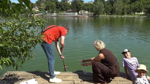 Sanitary service officer testing river water quality during hot summer heatwave. Stock Footage 342118260