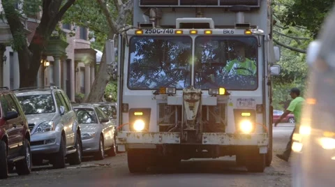 Sanitation worker collecting garbage in garbage truck Stock Footage 61133046