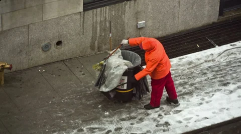 Sanitation worker NYC cleaning garbage snow cold winter street New York City Stock Footage 33545014