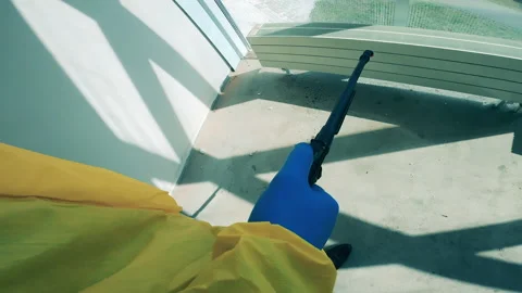 Sanitation worker uses spraying machine to disinfect room. Stock Footage 131170462