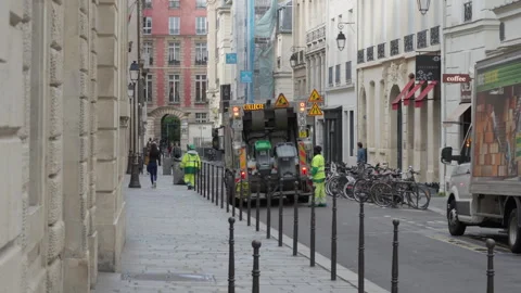 Sanitation workers collecting waste with garbage truck on European city street Stock-Footage 336722852