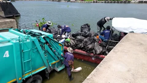 Sanitation Workers Loading Trash Bags from Boat into Garbage Truck Stock Footage 339514050