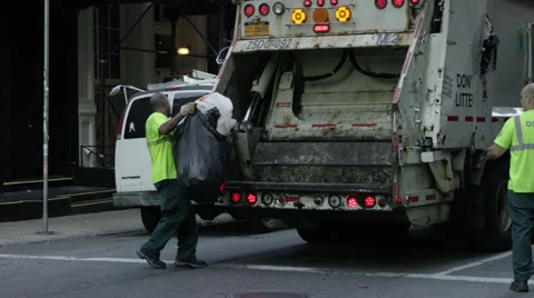 Sanitation workers loading trash into garbage truck in SoHo 4K slow motion NYC Stock Footage 54622101