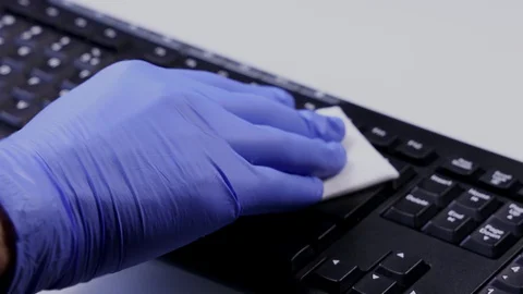 Sanitizing and Disinfecting Computer Keyboard Against Coronavirus COVID-19. Stock Footage 129769200