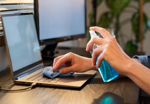 Sanitizing computer or laptop keyboard coronavirus protection Stock Photos