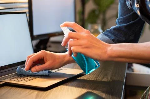 Sanitizing computer or laptop keyboard coronavirus protection Stock Photos