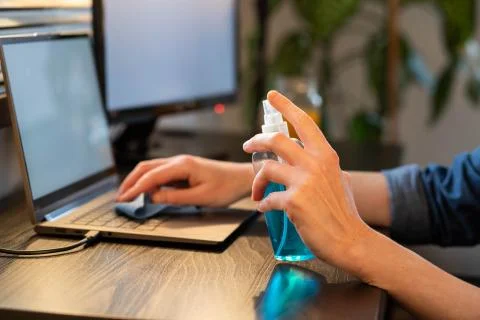 Sanitizing computer or laptop keyboard coronavirus protection Stock Photos