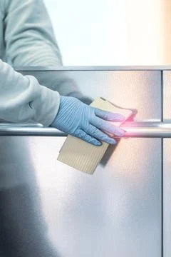 Sanitizing an elevator push button against bacteria and virus. Foto stock