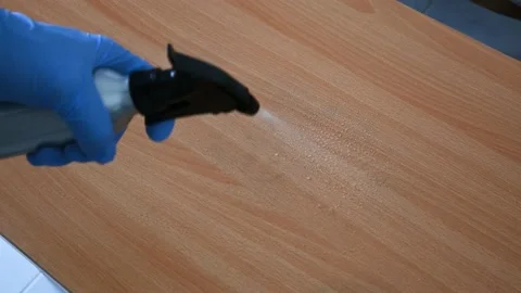 Sanitizing a table with gloves on due to COVID-19 outbreak. Stock Footage 134965195