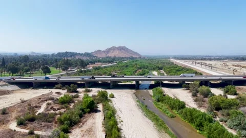 Santa Ana River Bed and Highway Bridge in Riverside, California Stock Footage 345537325