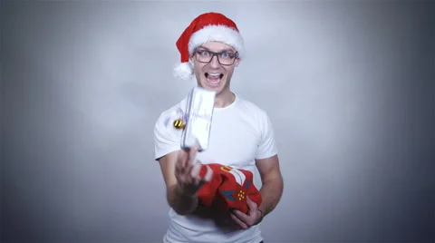 Santa christmas guy in red hat holding and opening gift. Stock Footage 44907283