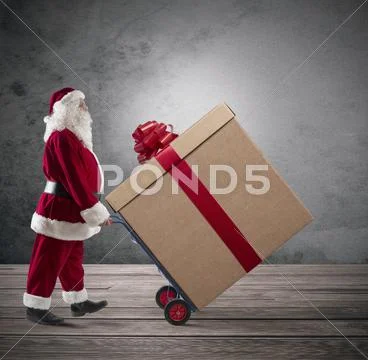 Santa claus with big christmas present Stock Photos