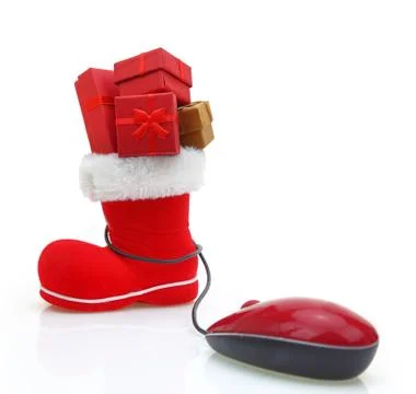 Santa Claus boot with gift boxes connected to a computer mouse Stock Photos