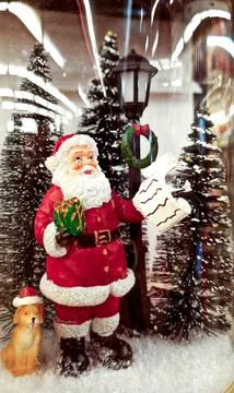 Santa Claus checking the list of good children with his dog Stock Photos