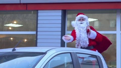 Santa Claus is dancing in the back of a pickup truck Stock Footage 136594203
