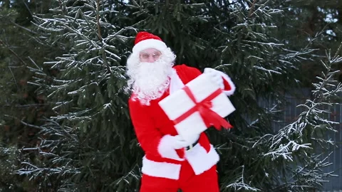 Santa Claus is dancing with a box Stock Footage 166945693