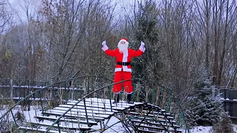 Santa Claus is dancing on the bridge Stock Footage 165898321