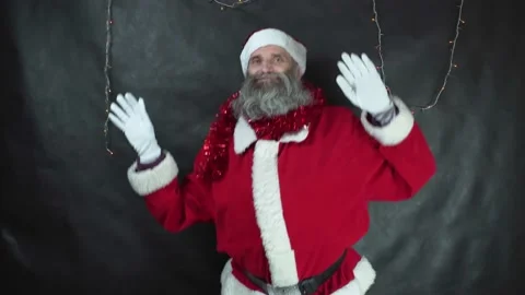 Santa claus is dancing on dark gray background. Strange middle-aged man with Stock Footage 221429241