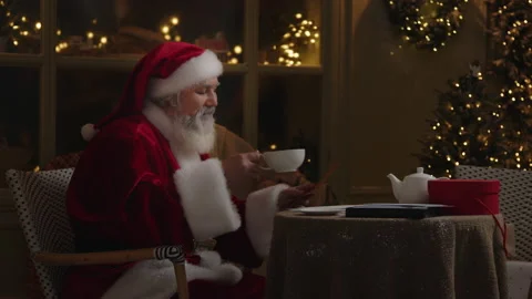 Santa Claus Is Drinking Tea and Reading Letter Stock Footage 220152200
