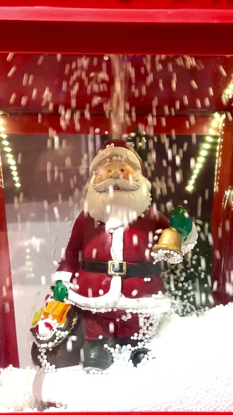 Santa Claus Figure Surrounded by Falling Snow in Christmas Holiday Display Stock Footage 323315726