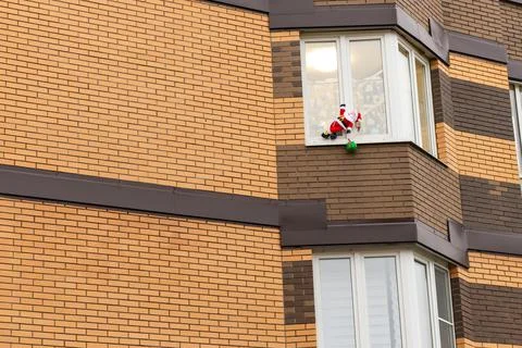 Santa Claus Frost climbs through the window Stock Photos