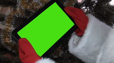 Santa claus gets on the hip a plane-table with a green screen Stock Footage 33221490