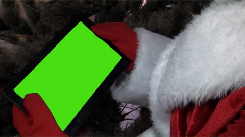 Santa claus gets on the hip a plane-table with a green screen Stock Footage 33221496