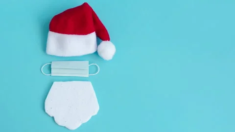 Santa Claus hat and beard with face mask on a blue background, creative minimal Stock Footage 140927682