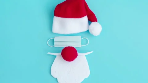 Santa Claus hat and beard with face mask on a blue background, creative minimal Stock Footage 140959641