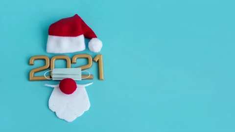 Santa Claus hat and beard with face mask on a blue background, creative minimal Stock Footage 141008199