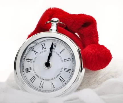 Santa claus hat on a clock Stock Photos