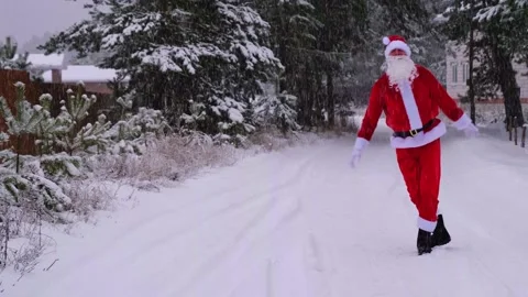 Santa Claus is having fun and funny dancing, shows acrobatic tricks, elemen.. Stock Footage 231035929