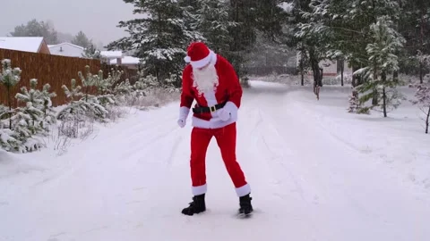 Santa Claus is having fun and funny dancing, shows acrobatic tricks, elemen.. Stock Footage 231095076