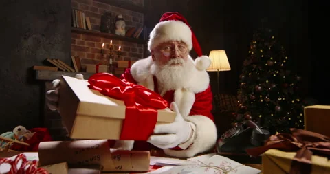 Santa Claus holding New Year present close-up. Talking on video call, using Stock Footage