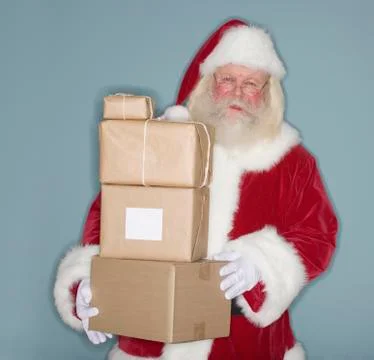 Santa Claus holding stack of packages Stock Photos