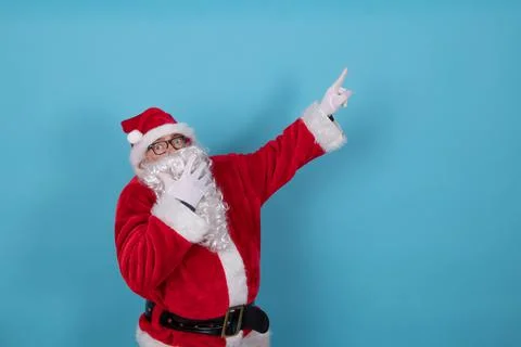 Santa claus isolated on background pointing 스톡 사진