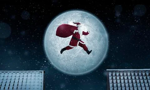 Santa Claus jumping between rooftops at night Stock Photos