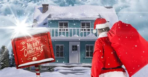 Santa Claus looking at  3d winter scenery with house Foto stock