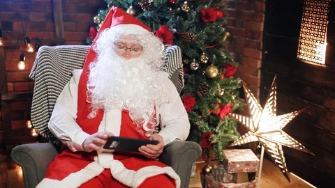 Santa claus looking at the tablet Stock Footage 84008734