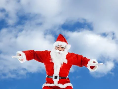 Santa Claus mimics a plane while flying Stock Photos