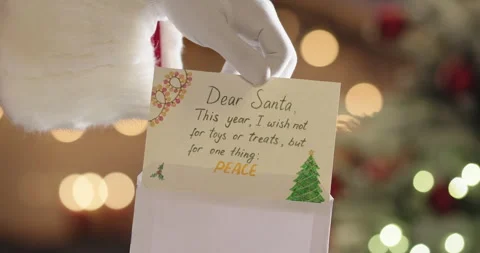 Santa Claus opening and reading letter Dear Santa, This year I wish not for toys Stock Footage 255166873