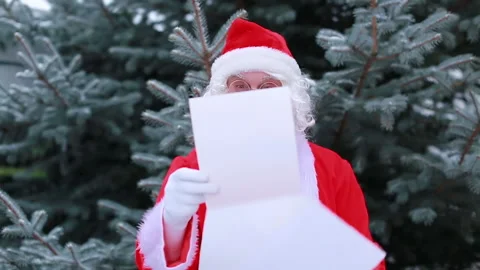 Santa Claus opens the envelope with the letter Stock Footage 165461555