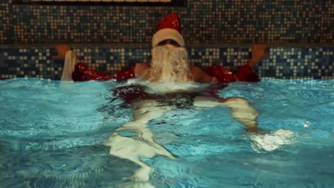 Santa claus in the pool Stock Footage 130767161