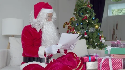 Santa Claus preparing to distribute present for children Stock Footage 119857718